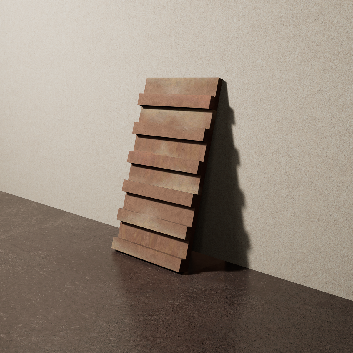 a 15"x8" bespoke dimensional concrete tile with six evenly spaced tiers leans against a textured, plaster wall on an unfinished concrete floor