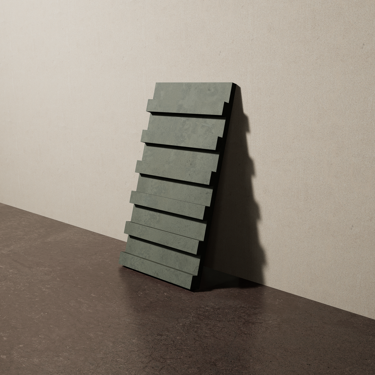 a 15"x8" bespoke dimensional concrete tile with six evenly spaced tiers leans against a textured, plaster wall on an unfinished concrete floor