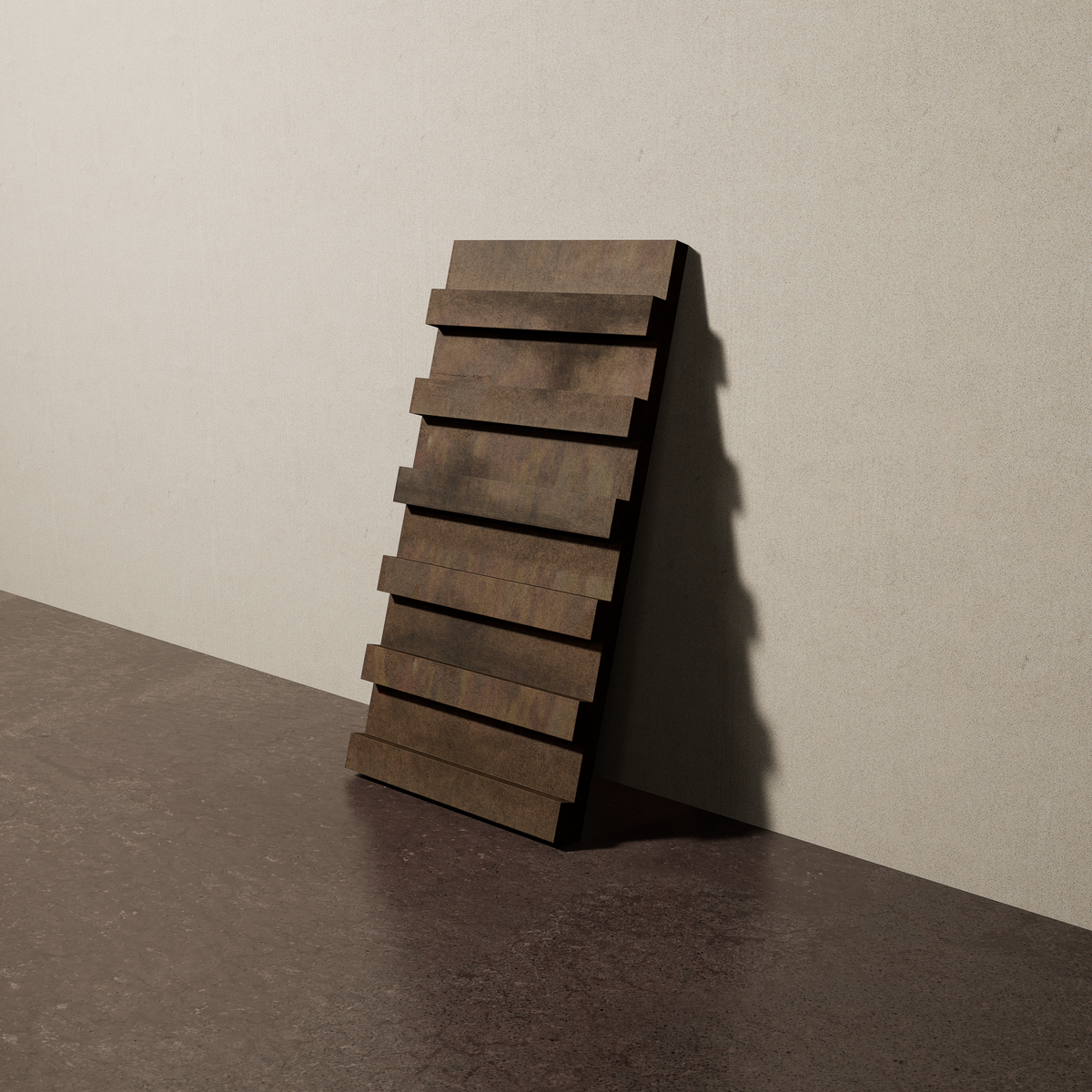 a 15"x8" bespoke dimensional concrete tile with six evenly spaced tiers leans against a textured, plaster wall on an unfinished concrete floor