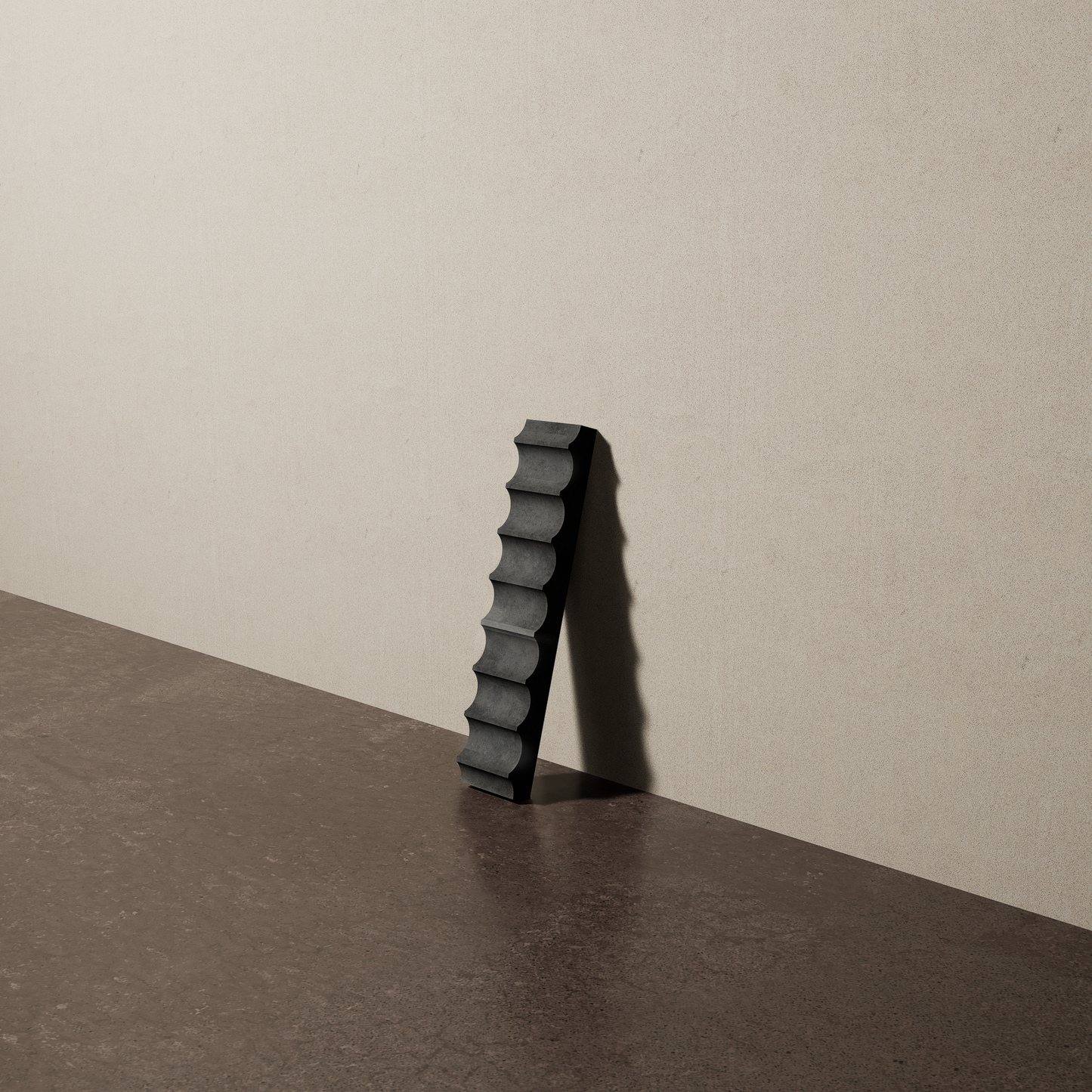 a 2"x10" bespoke fluted concrete tile with eight peaks leans against a textured, plaster wall on an unfinished concrete floor