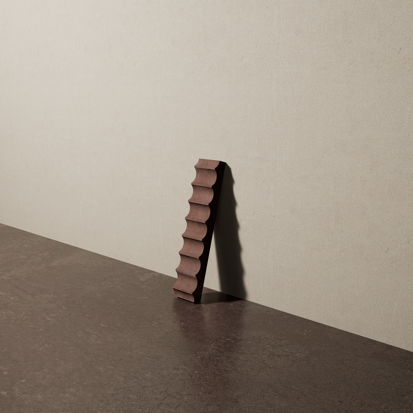 a 2"x10" bespoke fluted concrete tile with eight peaks leans against a textured, plaster wall on an unfinished concrete floor