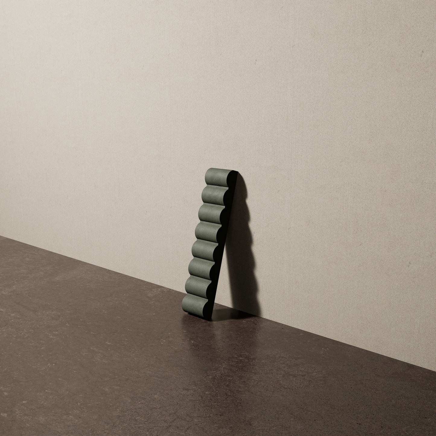 a 2"x10" bespoke reeded concrete tile with eight ribs leans against a textured, plaster wall on an unfinished concrete floor
