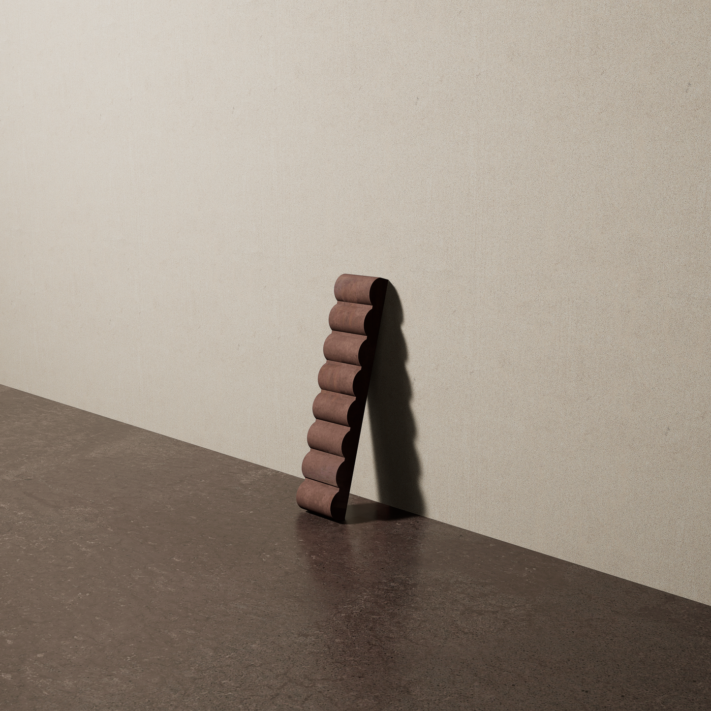 a 2"x10" bespoke reeded concrete tile with eight ribs leans against a textured, plaster wall on an unfinished concrete floor